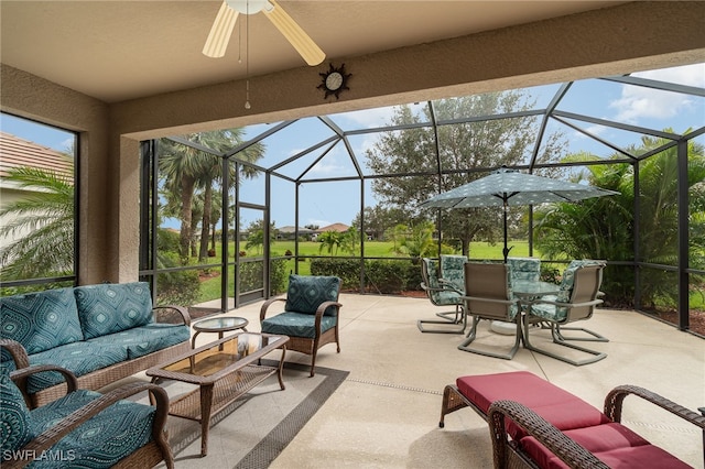 view of patio featuring an outdoor hangout area, glass enclosure, and ceiling fan