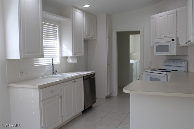 kitchen featuring white cabinetry, sink, light tile patterned floors, and white appliances