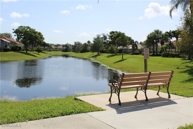 surrounding community with a lawn and a water view