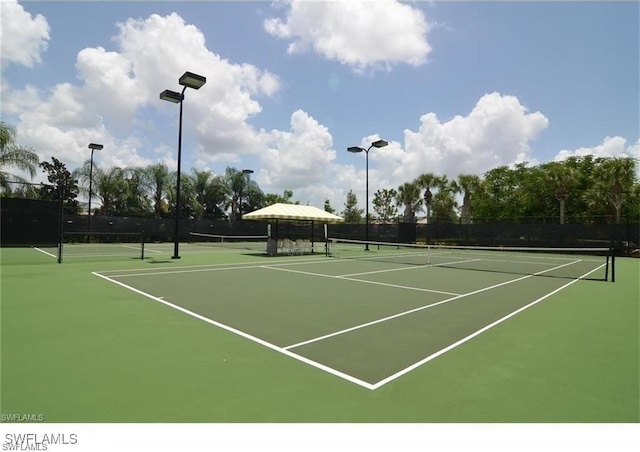 view of tennis court with basketball hoop