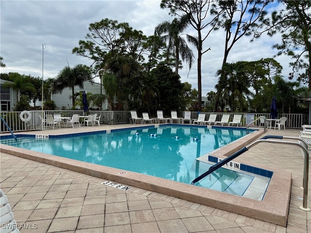 view of swimming pool featuring a patio area