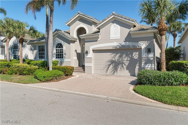 mediterranean / spanish home with a garage