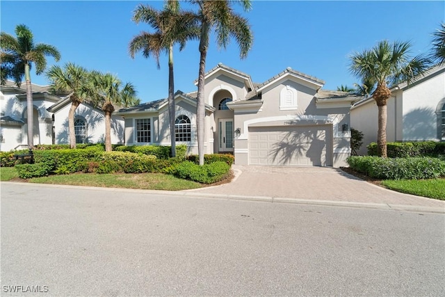 mediterranean / spanish-style home featuring a garage