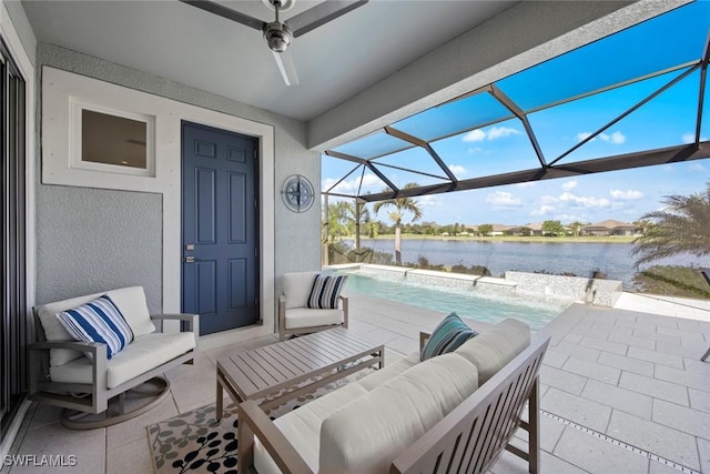 view of patio / terrace featuring a lanai, a water view, and an outdoor hangout area