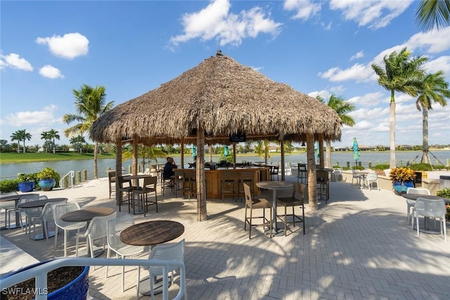 view of home's community featuring a gazebo, a water view, and exterior bar