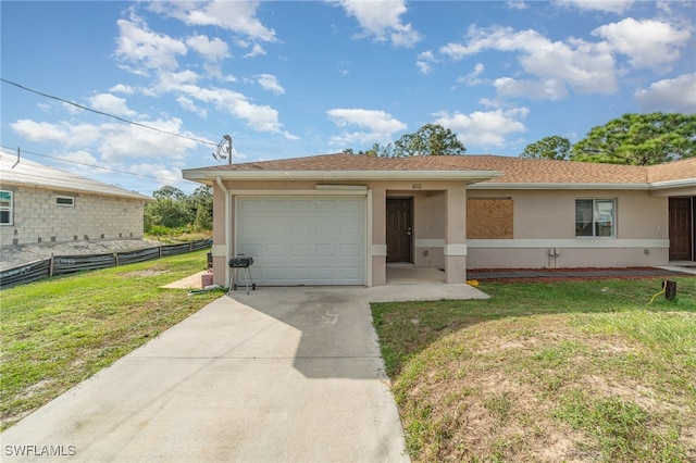 view of front of house featuring a front yard and a garage