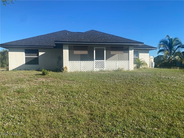 rear view of house with a lawn