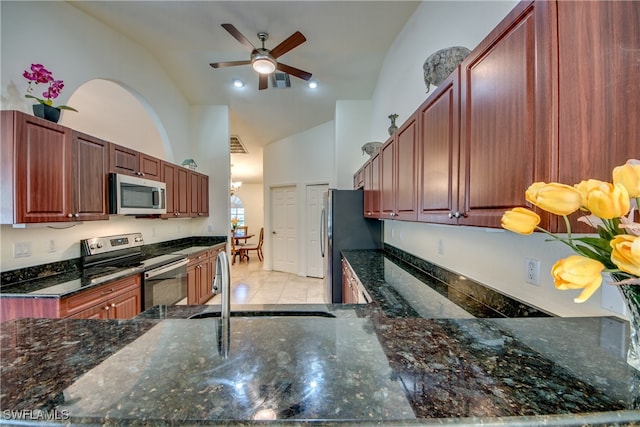 kitchen featuring stainless steel appliances, ceiling fan, sink, high vaulted ceiling, and dark stone countertops