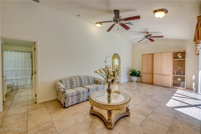 living area with high vaulted ceiling, ceiling fan, and light tile patterned flooring