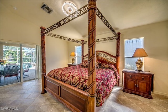 tiled bedroom with access to exterior and vaulted ceiling