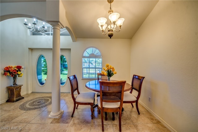 dining area featuring ornate columns, a chandelier, and lofted ceiling