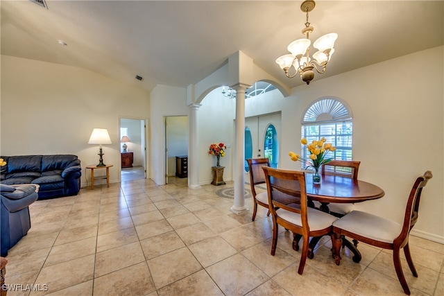 tiled dining space featuring ornate columns, lofted ceiling, and an inviting chandelier