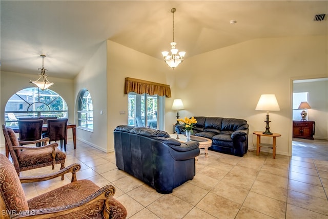 living room with a chandelier, light tile patterned floors, a wealth of natural light, and vaulted ceiling