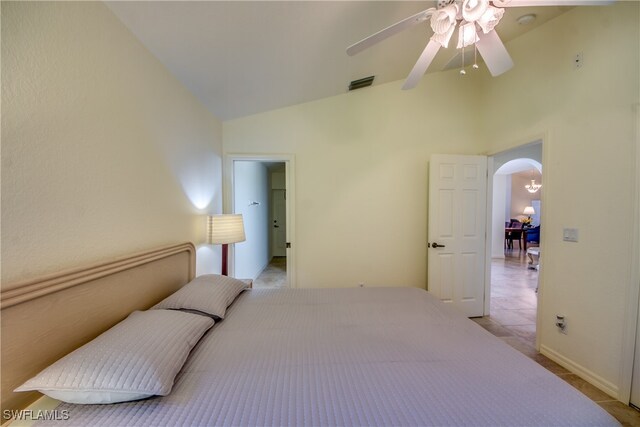 tiled bedroom featuring ceiling fan and high vaulted ceiling