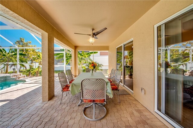 view of patio / terrace with a lanai and ceiling fan