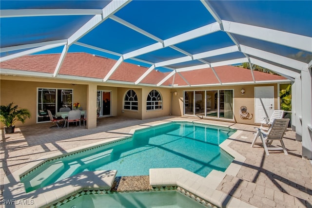 view of swimming pool featuring a patio and glass enclosure