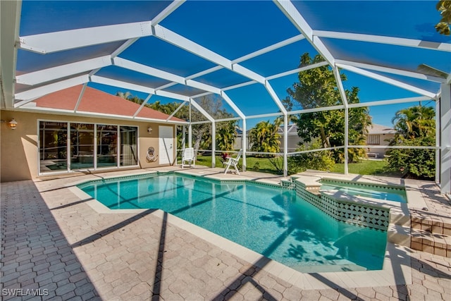 view of swimming pool featuring an in ground hot tub, a patio area, and a lanai