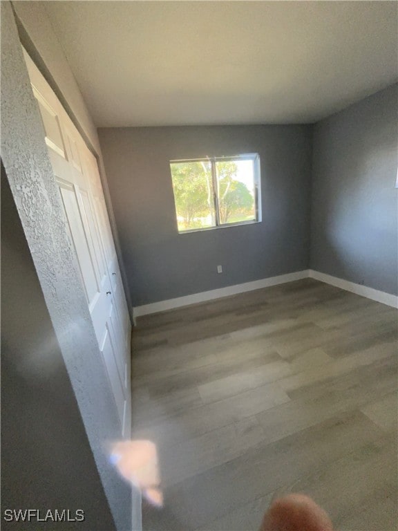 empty room with light hardwood / wood-style flooring