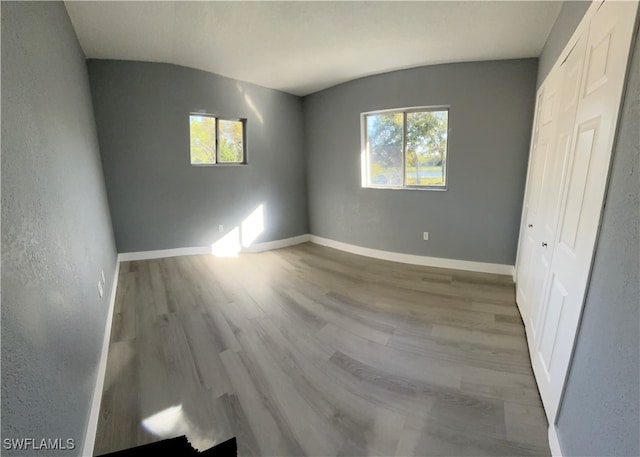 unfurnished bedroom featuring a closet and light wood-type flooring