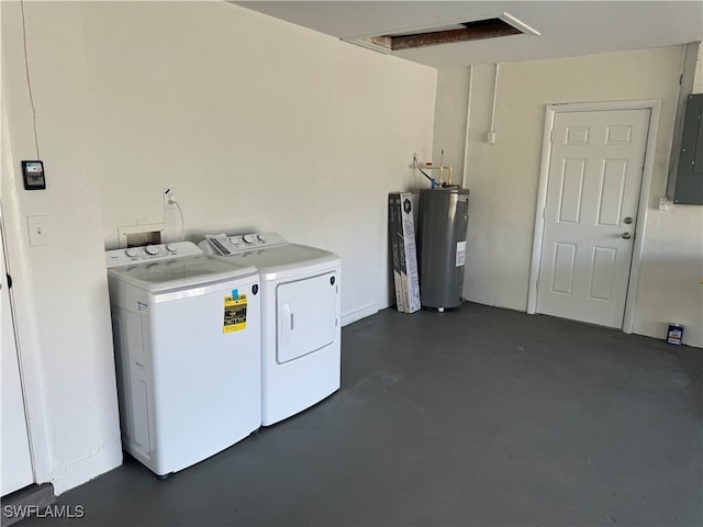 clothes washing area featuring washing machine and dryer, water heater, and electric panel