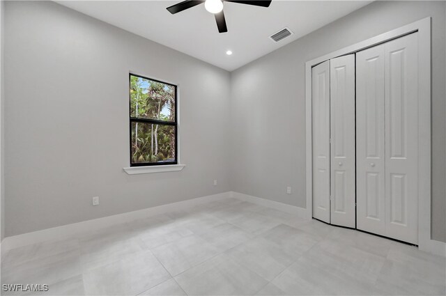 unfurnished bedroom featuring a closet and ceiling fan