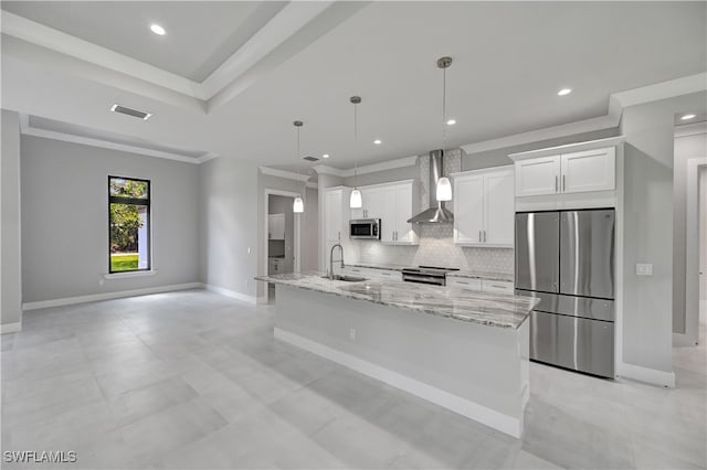 kitchen featuring backsplash, sink, wall chimney exhaust hood, appliances with stainless steel finishes, and white cabinetry