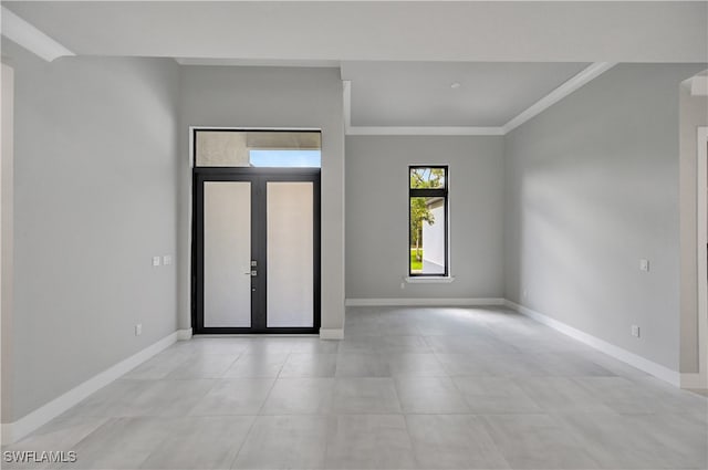 entryway with crown molding and french doors