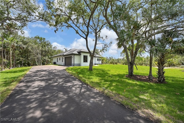 view of front of house with a garage and a front yard