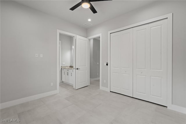 unfurnished bedroom with ceiling fan and a closet