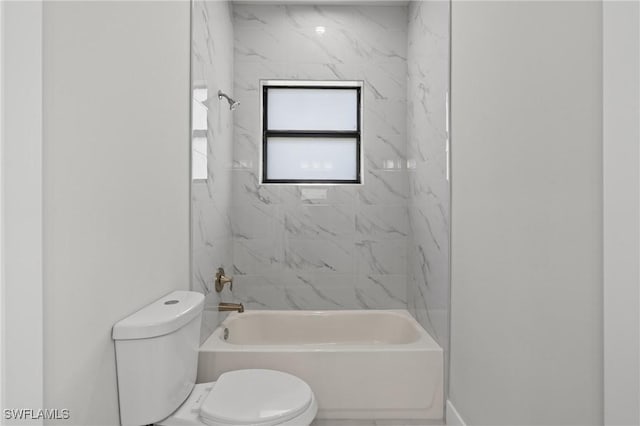 bathroom featuring tiled shower / bath and toilet