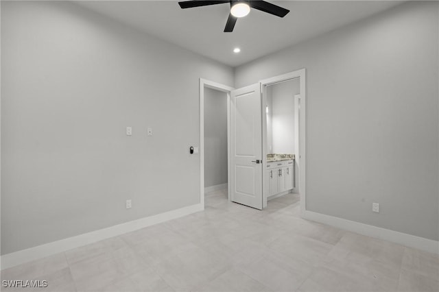 unfurnished bedroom with ceiling fan and connected bathroom