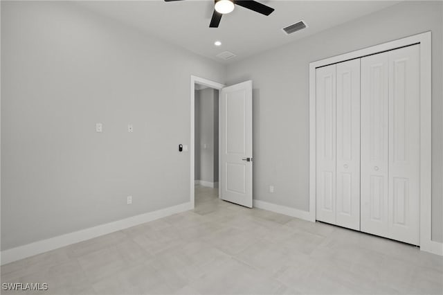 unfurnished bedroom with ceiling fan and a closet