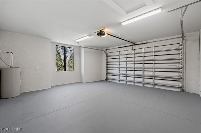 garage with water heater and a garage door opener