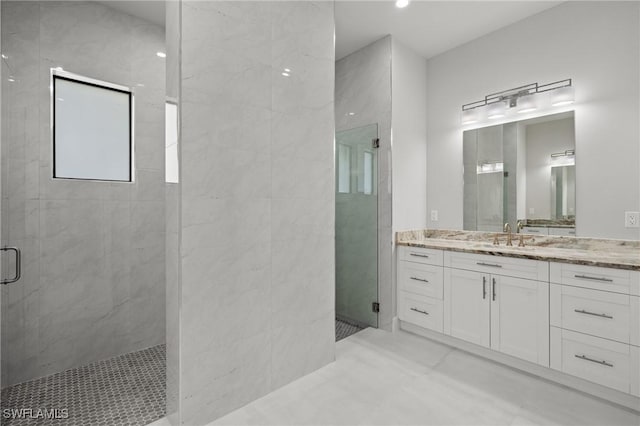 bathroom featuring vanity and a shower with shower door