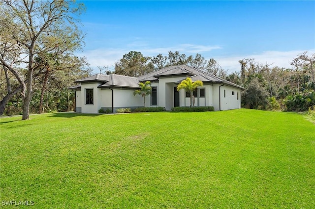 rear view of property featuring a yard