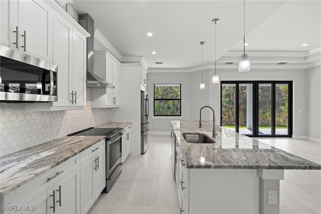 kitchen with sink, decorative light fixtures, white cabinets, and appliances with stainless steel finishes