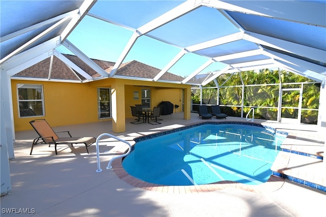 view of swimming pool with a patio and a lanai