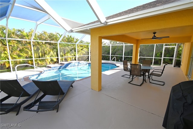 view of swimming pool featuring a lanai, ceiling fan, and a patio area