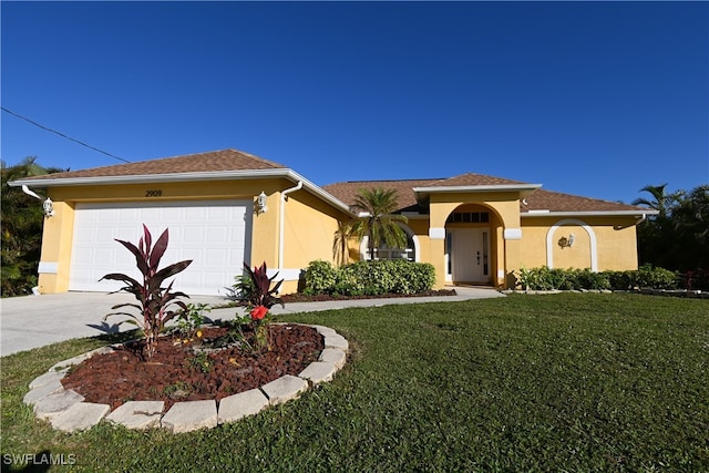 view of front of home with a garage and a front yard