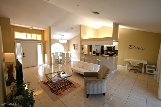 living room with light tile patterned flooring and vaulted ceiling