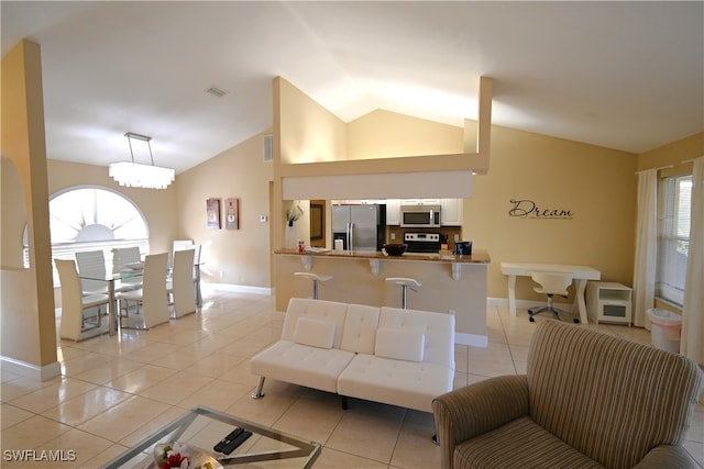 living room with light tile patterned flooring, lofted ceiling, and a notable chandelier