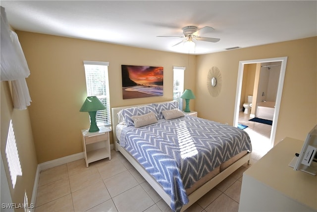 bedroom featuring ensuite bath, ceiling fan, and light tile patterned floors