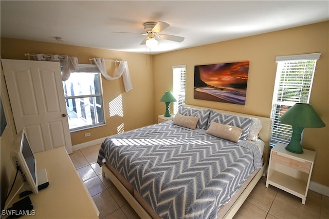 bedroom with light tile patterned flooring, multiple windows, and ceiling fan