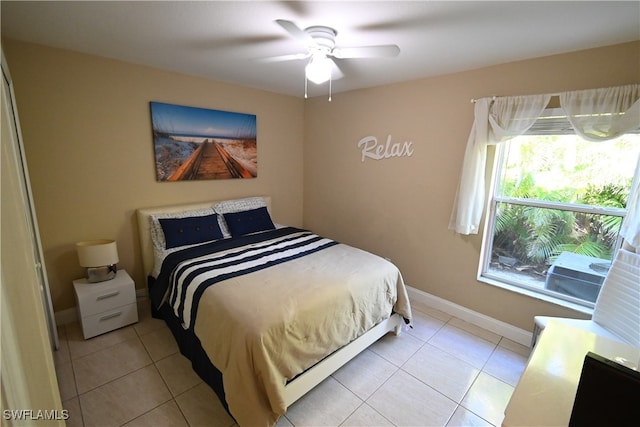 bedroom with ceiling fan and light tile patterned floors