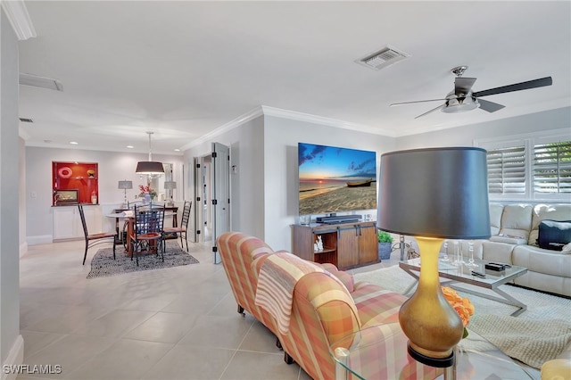 tiled living room featuring ceiling fan and ornamental molding