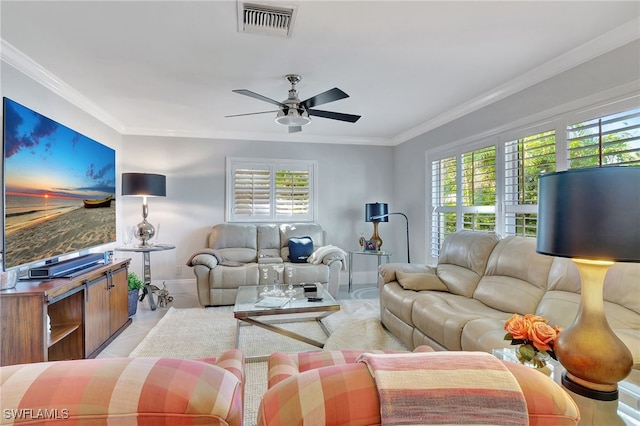 tiled living room with plenty of natural light, ceiling fan, and crown molding