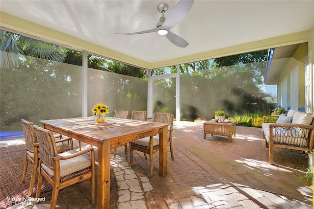 sunroom / solarium featuring ceiling fan