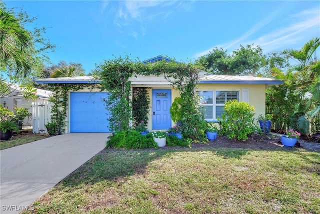 ranch-style house featuring a garage and a front yard