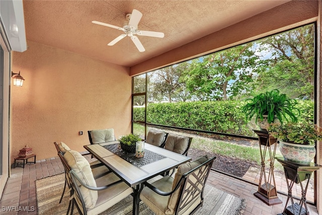 sunroom featuring ceiling fan