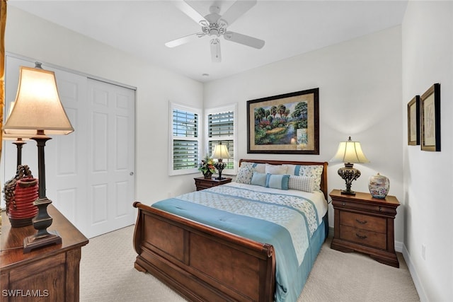 carpeted bedroom featuring ceiling fan and a closet